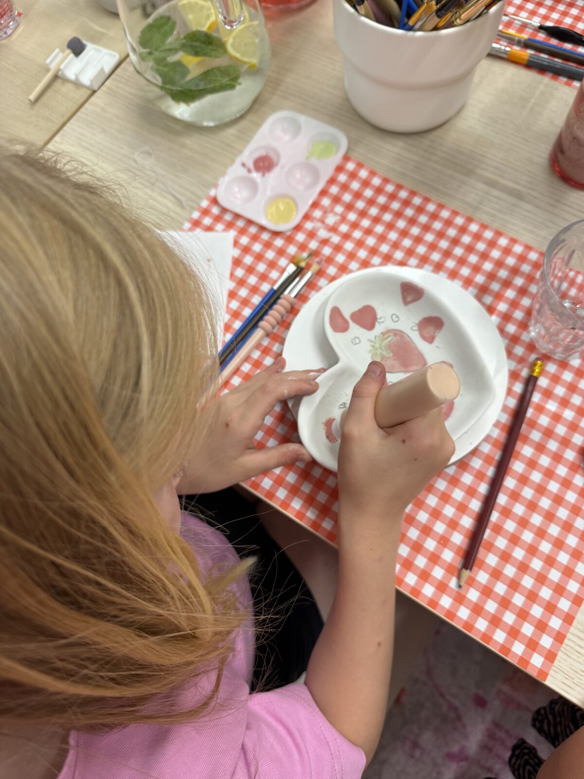 Kind beschildert een keramieken bordje tijdens een kinderfeestje bij ZoëZo Creatief in Odijk